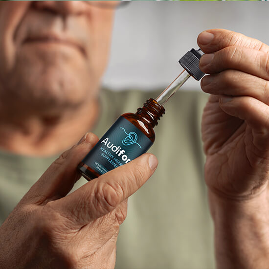 Man holding an Audifort dropper bottle